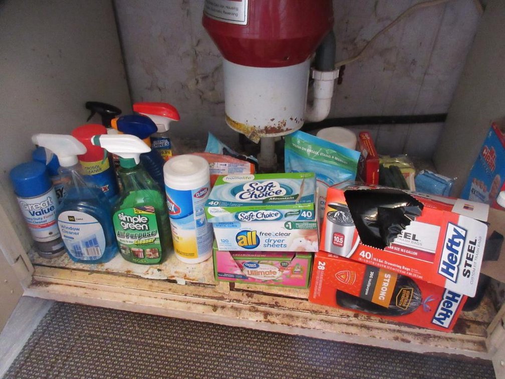Contents of 1 cabinet & 1 drawer in kitchen:  Cleaning supplies, trash bags, plastic wrap, tin foil