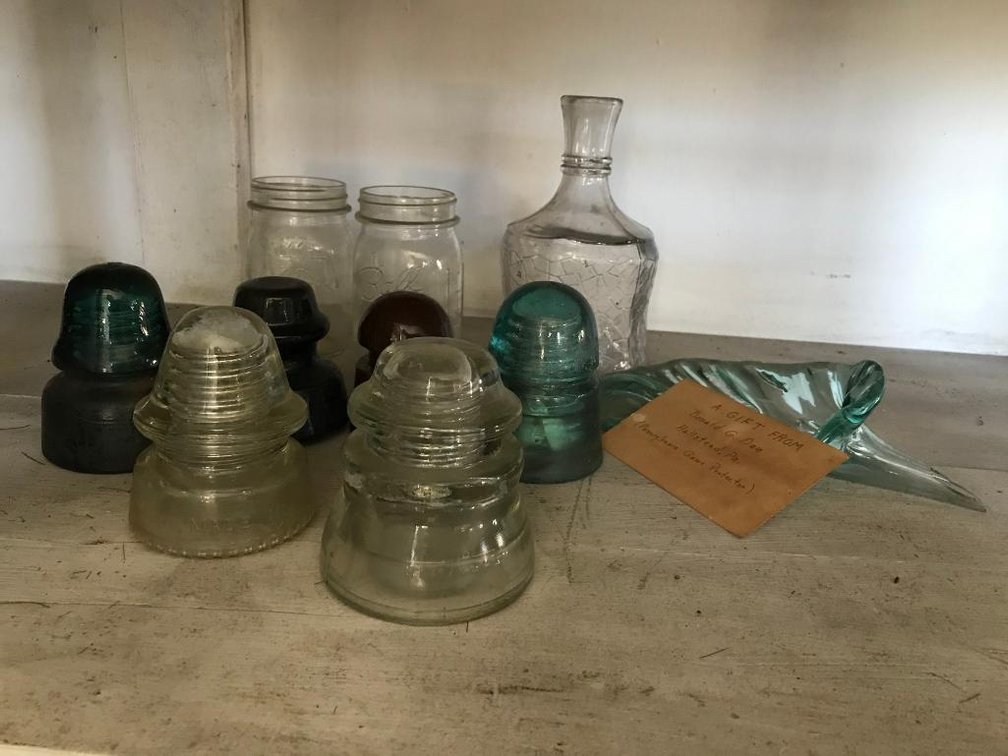 Collection of different colored insulators & canning jars