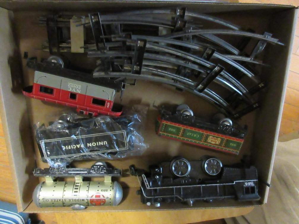 Marx Triple 6 wind-up engine, Union Pacific Tender, Rock Island open car #552, Santa Fe oil tanker 553, NYC caboose 20102 and some track