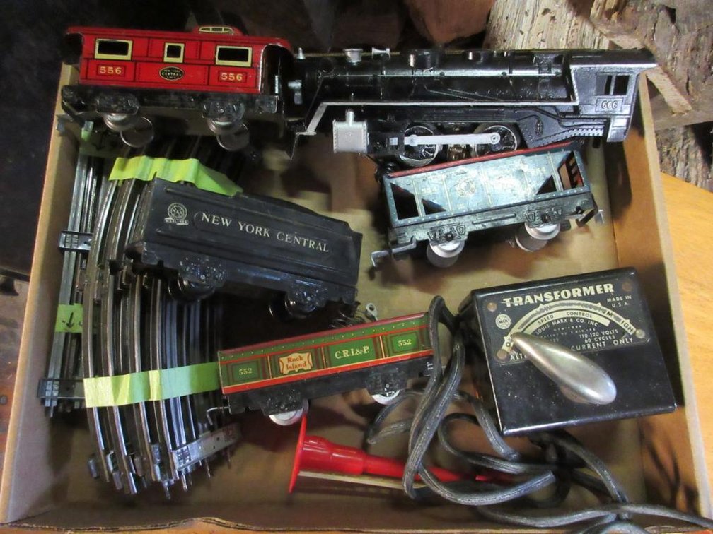 Marx Triple 6 engine, New York Central Tender, Rock Island open car #552, Northern Pacific coal car #554, New York Central caboose #556, pieces of track & a Marx transformer