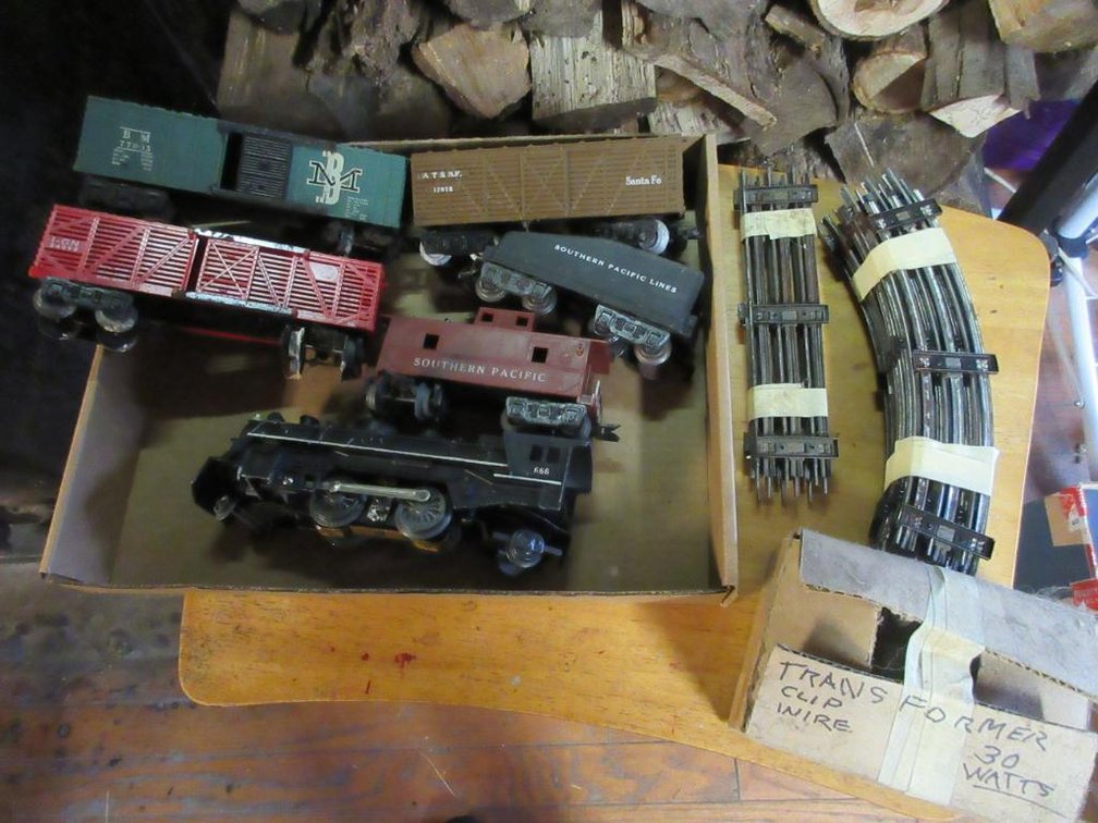 Pieces of track, Marx Triple 6 engine, Southern Pacific Lines Tender, Santa Fe box car 13975, BM box car 77003, Missouri Pacific Lines livestock car 54009, pieces of track, Southern Pacific caboose & transformer
