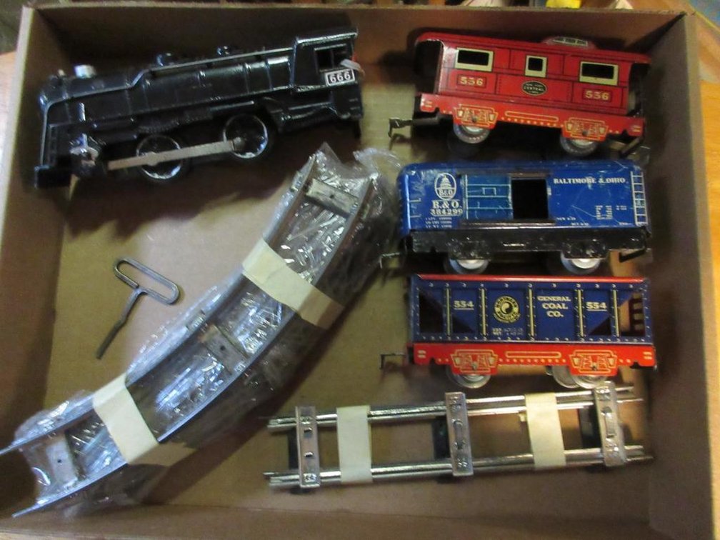 Marx Triple 6 wind-up engine, Northern Pacific coal car #554, Baltimore & Ohio boxcar #384299, pieces of track, New York Central Lines caboose 556