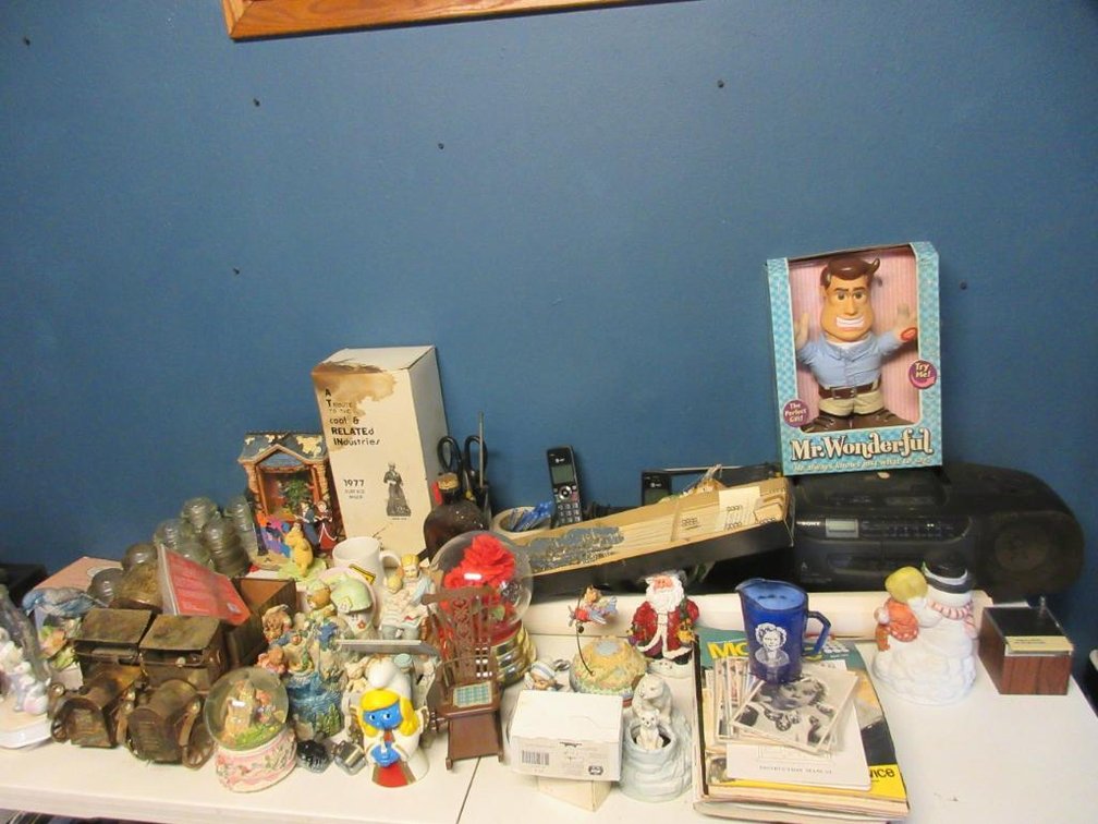 Contents on top of table to include Shirley Temple picture, Mr. Wonderful doll, glass insulators, tin trucks, etc.