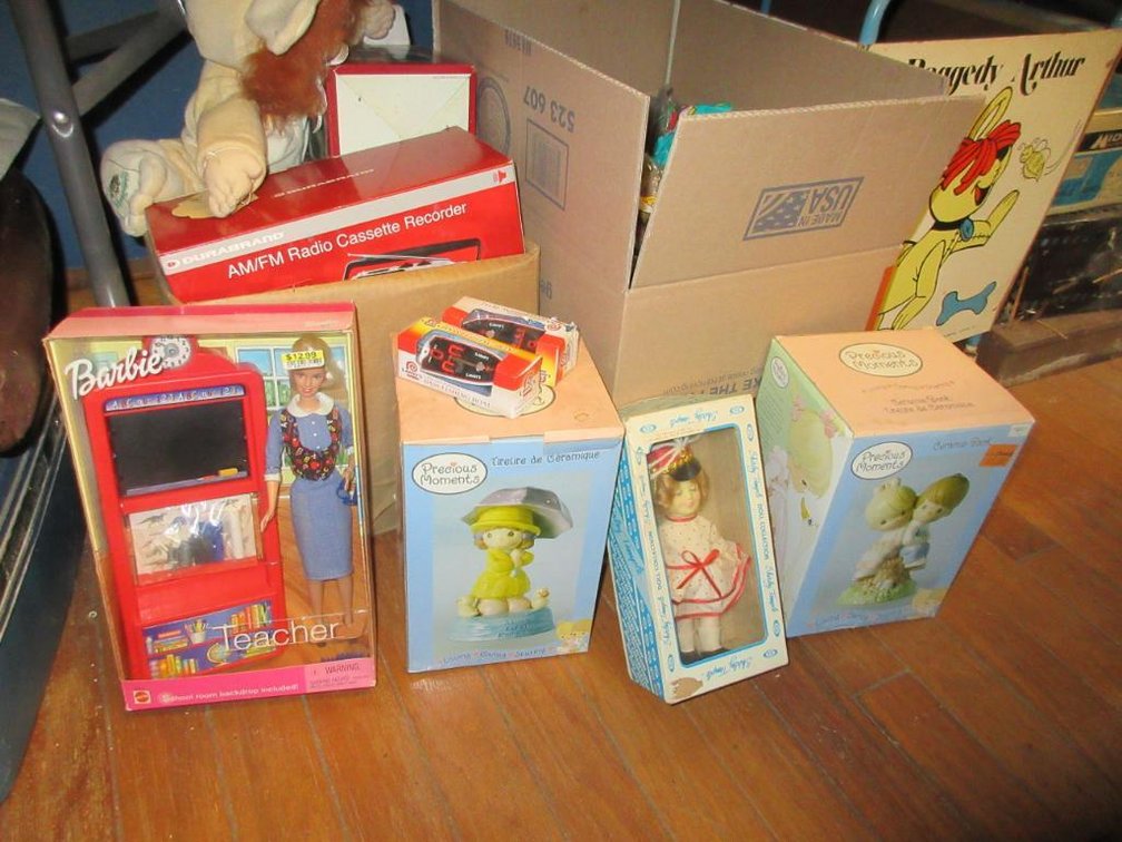 Contents under the table - Midland radio, Raggedy Arthur carriage, Beanie Babies, Barbies, radios, etc.