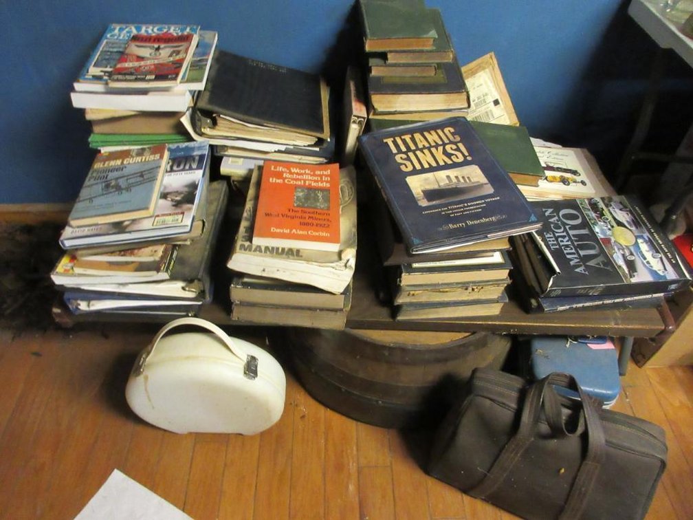 1 Lot of American Auto books, American coal mine books, Titanic books, World War II informational books, parts manuals, typewriter, etc.