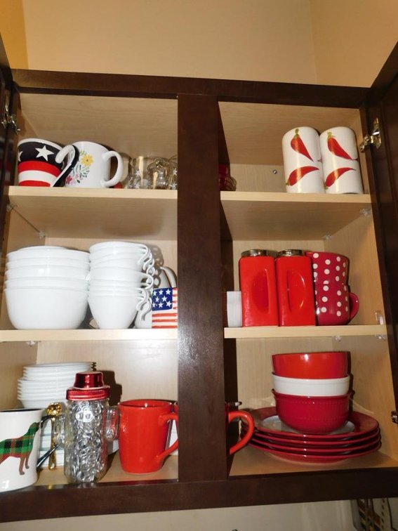 Contents of upper cabinet - red & white dishes, Corelle items