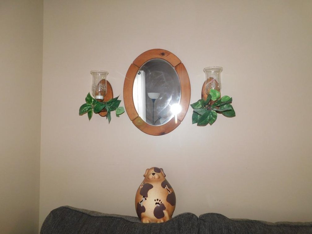 Wall grouping w/ mirror, sconces & dog decoration