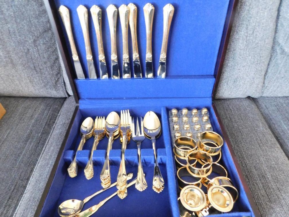 103-Piece entertaining ensemble includes golden flatware, salt & pepper shakers, napkin rings, serving pieces & candlesticks