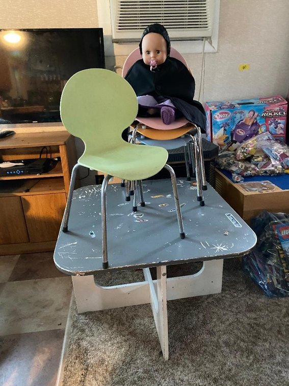 Wood child's table, 4 plastic & metal chairs, and Amish doll