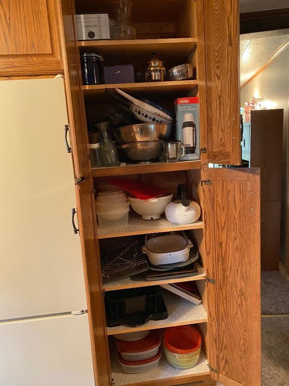 Contents tall cabinet: cookware, plastic ware, crock pot, etc