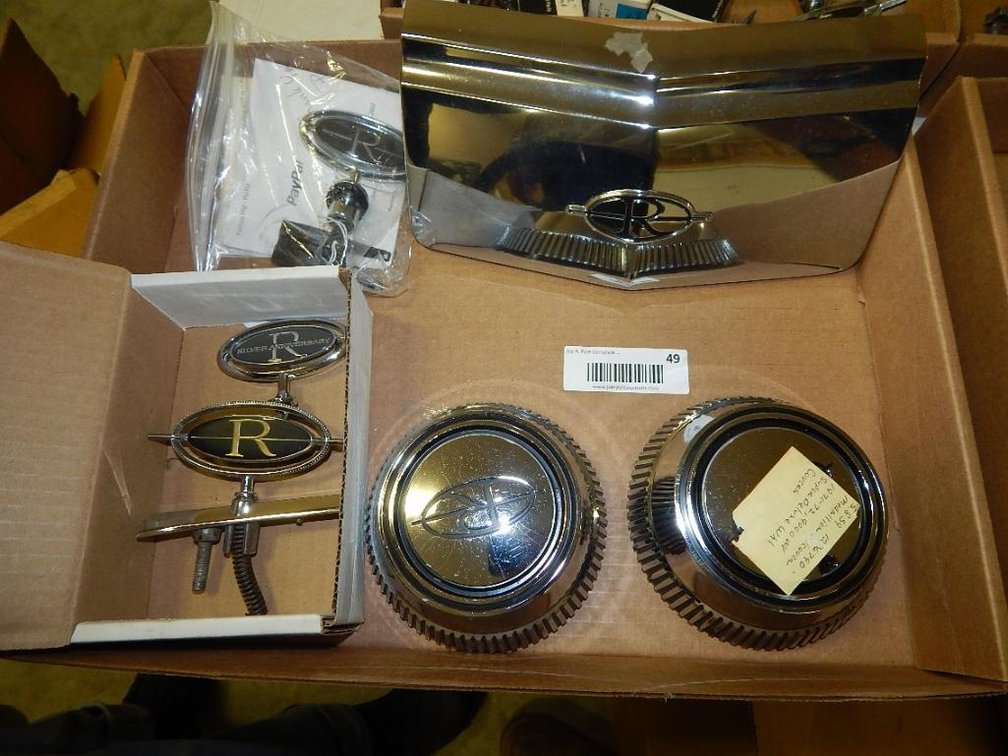 Flat of Buick Riviera emblems, center caps & grill insert