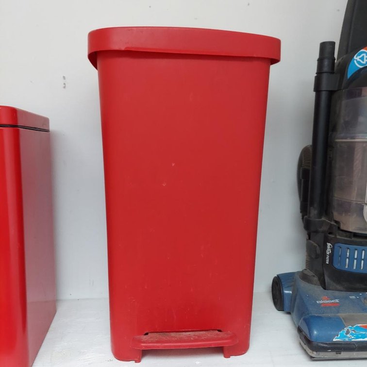 Red plastic trash can