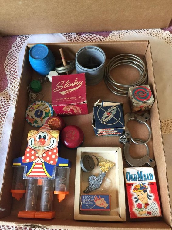 Vintage toys: Slinkys old maid, monkey in barrel, yo-yos, banks with a few wheat pennies
