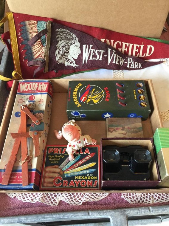 Vintage toys: tin crayon box, Bombsight game, wind-up crawling baby, West View pennant, etc.