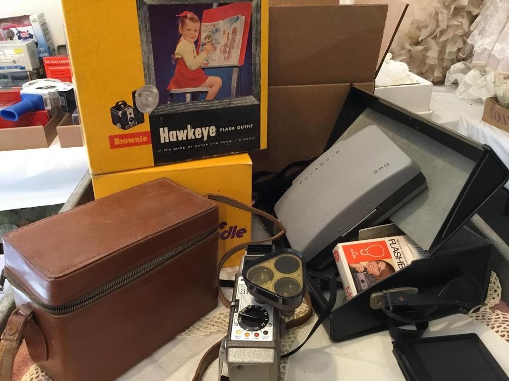 Camera lot: Hawkeye camera and flash unit, Polaroid 230 camera, Bell & Howell move camera