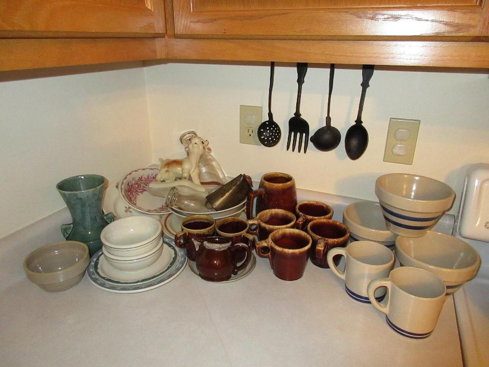 Collection of stoneware w/ Roseville cups & bowls & cowbell w/ Carr McNichol and Syracuse China
