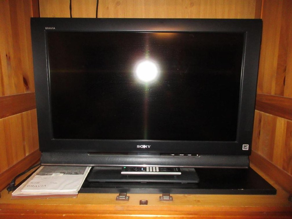 Sony 32" TV w/CD player, VHS player and assorted VHS & DVDs