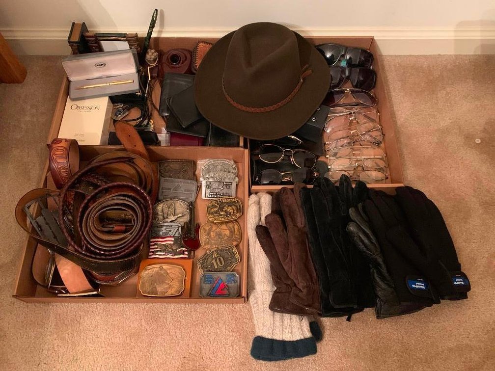 Lot of belts, belt buckles, eye glasses, and gloves