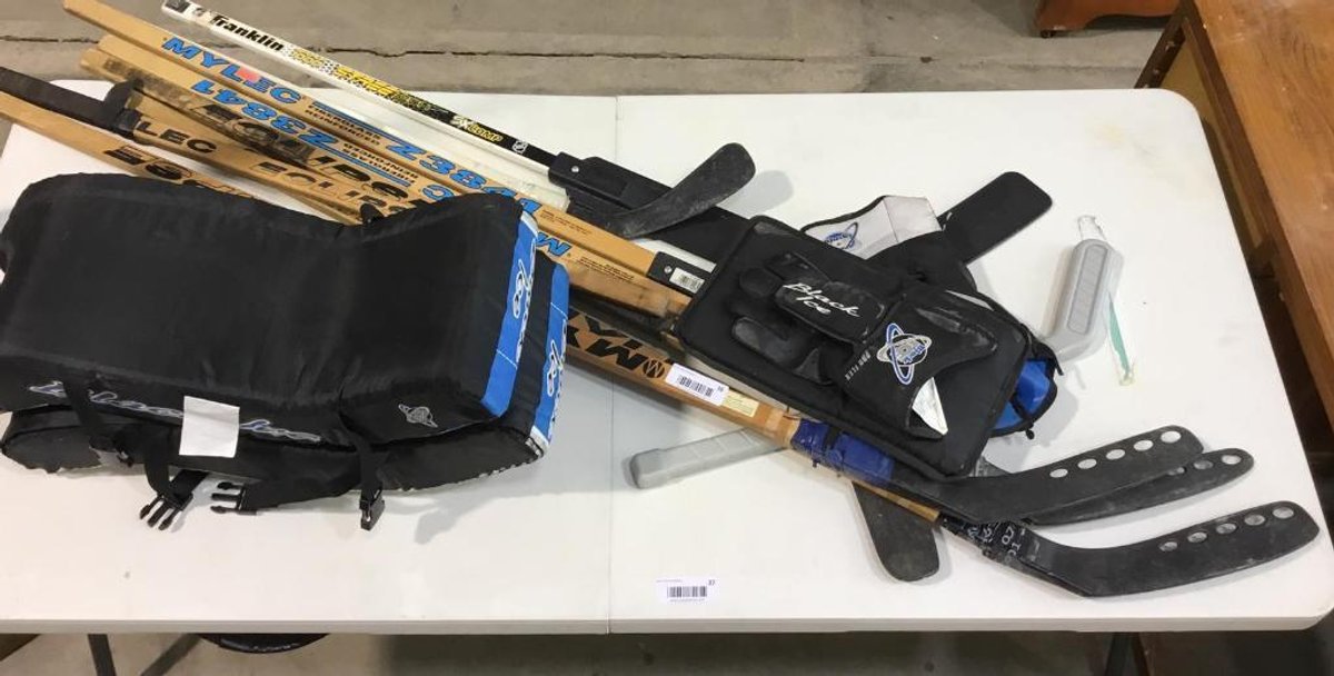 1 Lot of hockey sticks and hockey gear