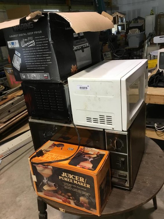 Lot of kitchen items: microwave, toaster oven, deep fryer and juicer
