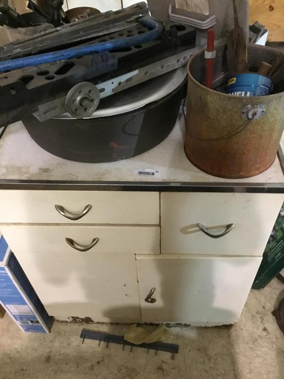 Kitchen cabinet and contents: nuts, bolts, saws, etc.