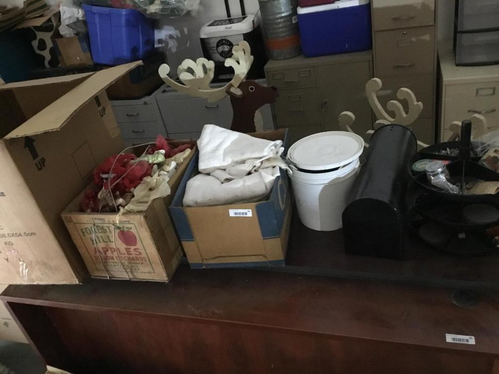 Contents on top of deck: figurines, shop towels, roto bin, etc.