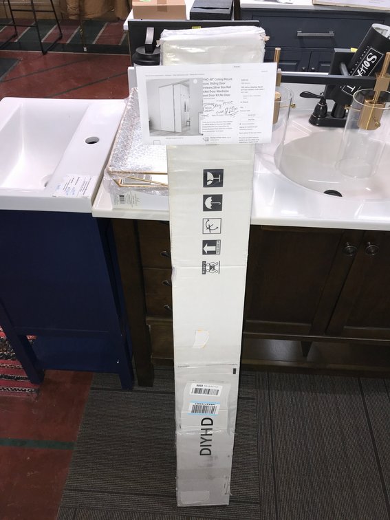 Ceiling mounted bypass hardware for a sliding door
