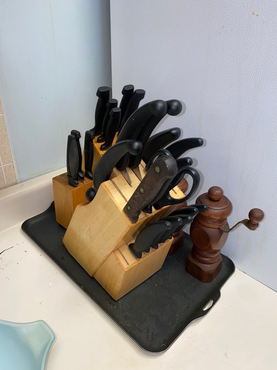Knives in wooden block, salt and pepper grinders