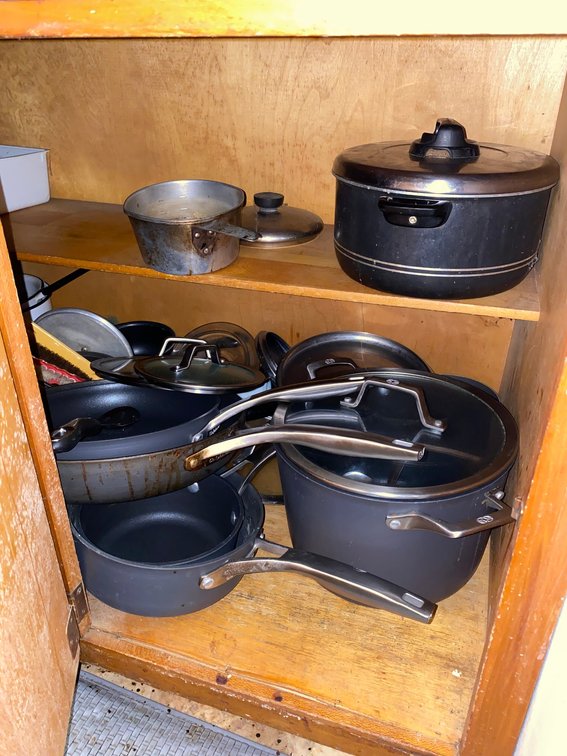 Contents of lower cabinets:  Kitchen utensils, pots, pans, baking pans, cleaning products