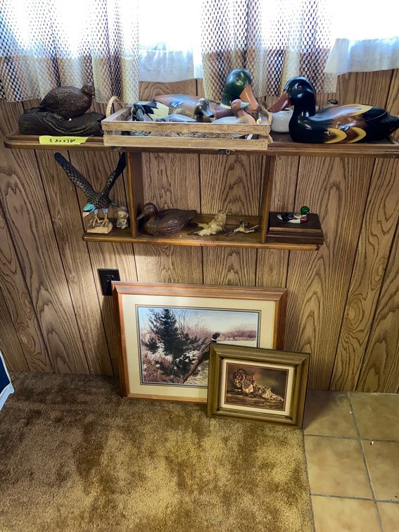 Contents of shelf: Numerous duck figurines and framed duck print