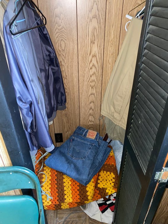 Contents of cabinet:  Levis Strauss jeans 505 size 44x32 and afghans