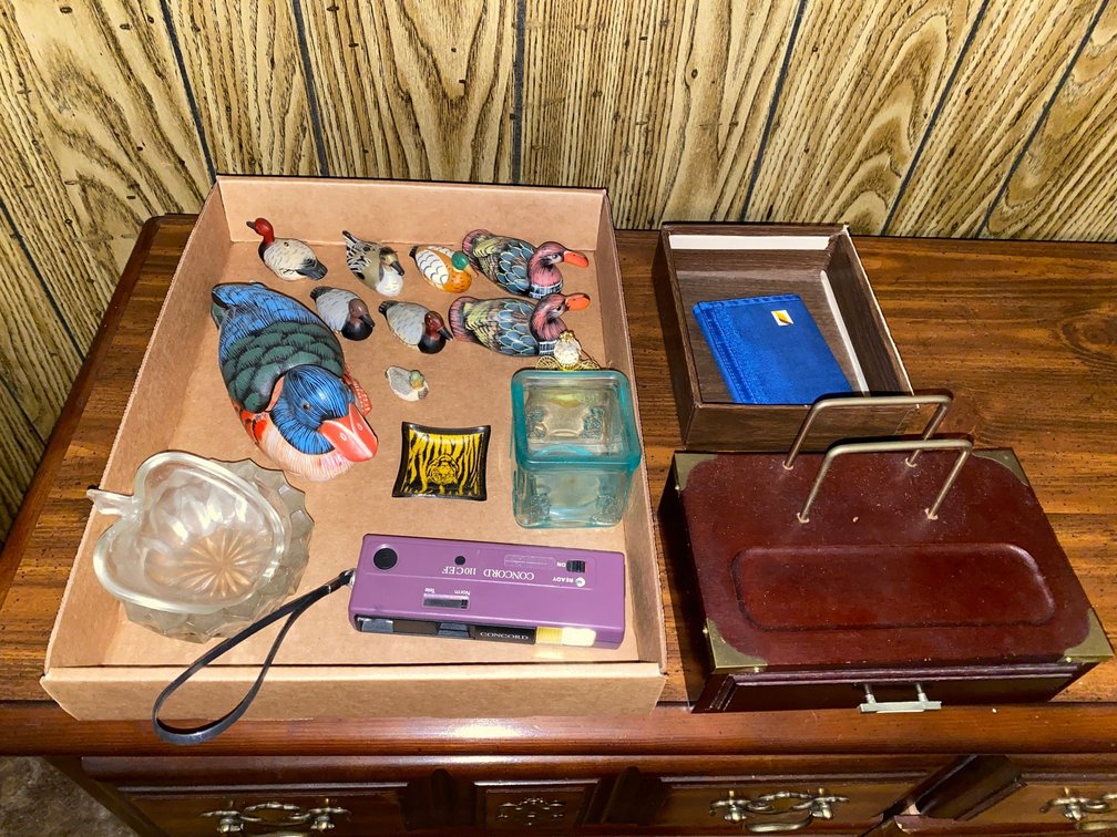Contents of flat:  Concord camera, men's jewel box, decorative duck items