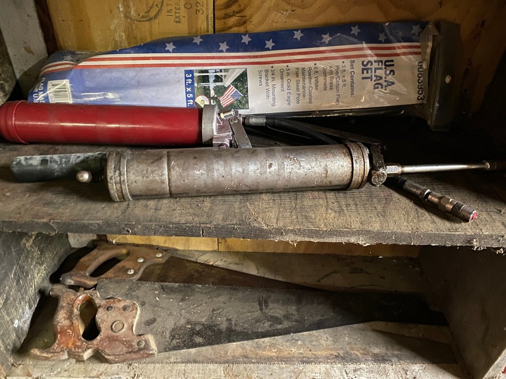 Shelf w/ grease guns and saws