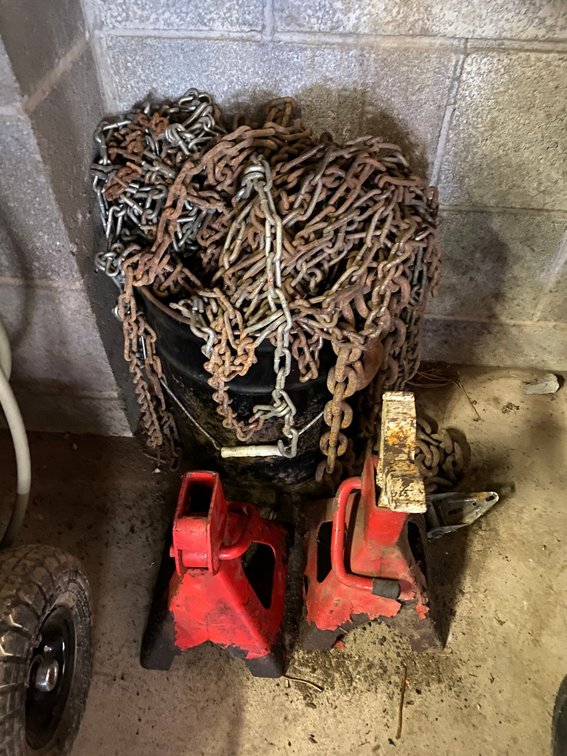 Bucket of car chains and jack stands (some pieces are missing)
