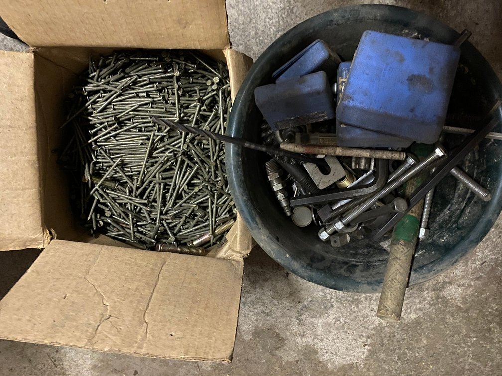 Bucket of scrap steel and box of nails