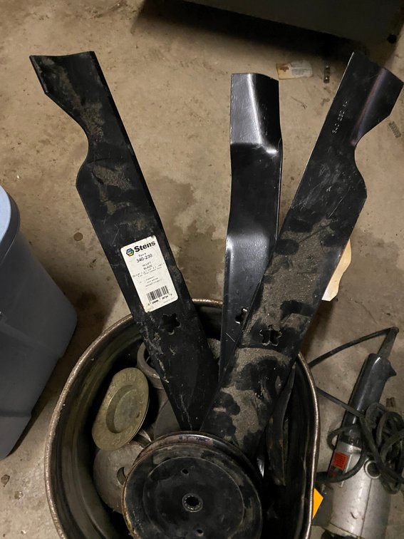 Bucket of assorted steel and some lawn mower blades