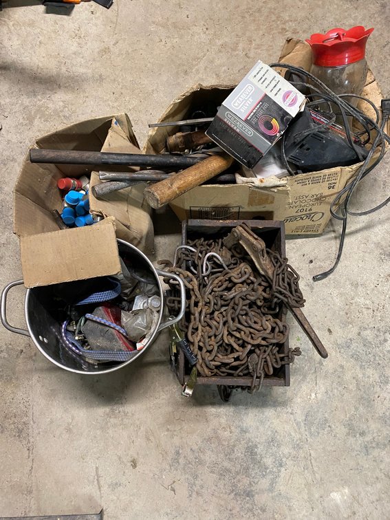 Pile of chain and misc. items:  Hydraulic ends, battery charger