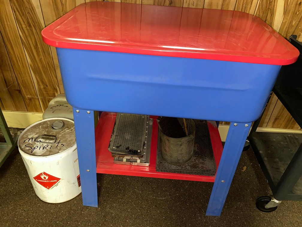 Parts washer and two containers of mineral spirits