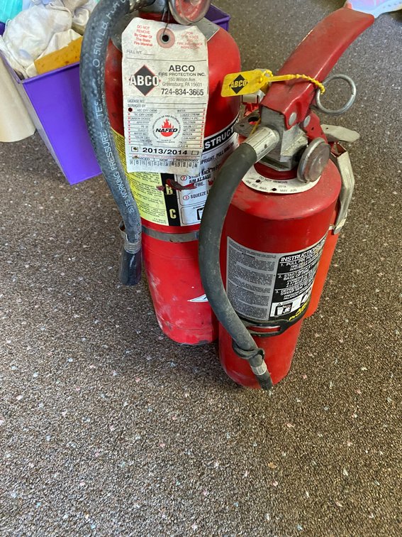 Four fire extinguishers, two in the green and two in the red