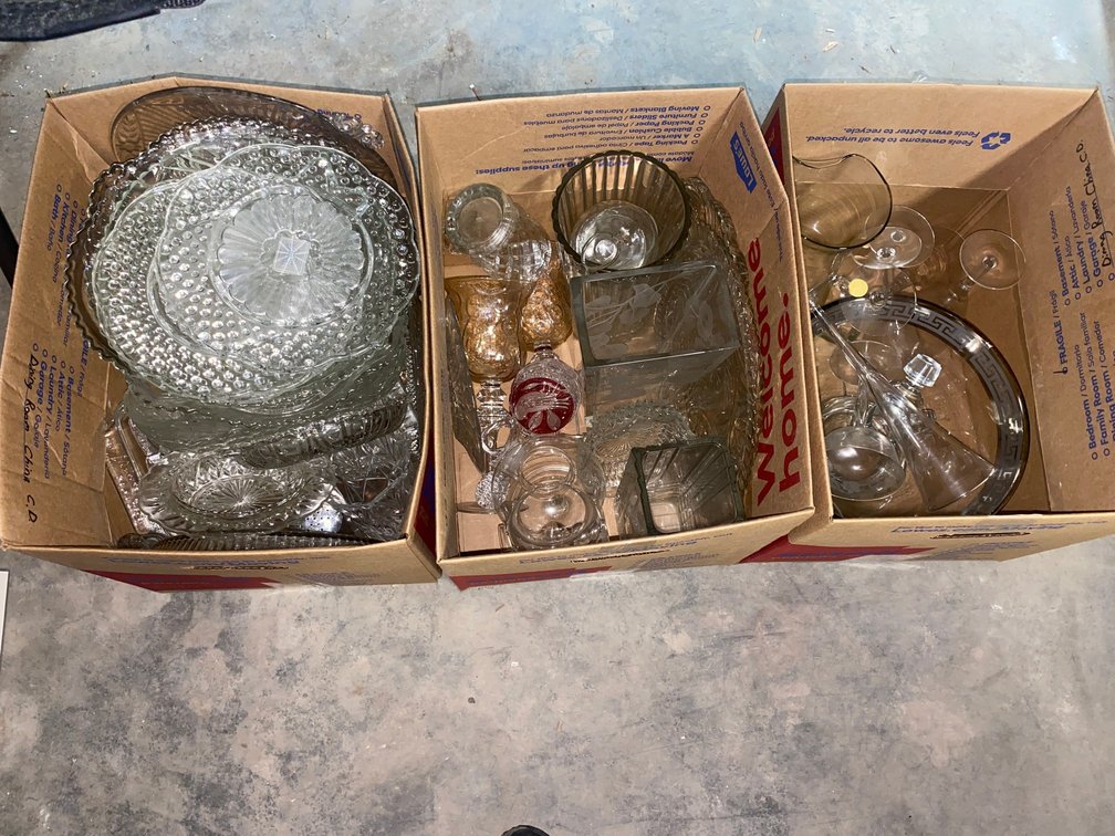 Clear glass serving platters, flower vases and stemware