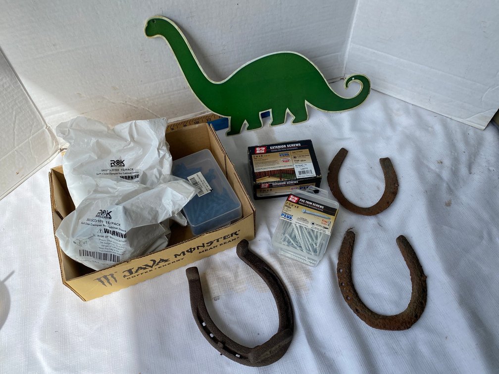 Tin dinosaur sign, 3 vintage horseshoes, assorted hardware, screws