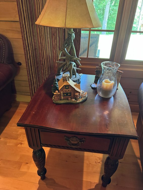 Wooden end table with table lamp, other decorations