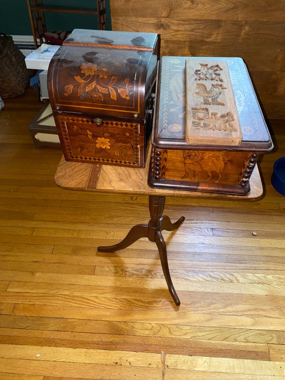 Wooden jewelry chest with wooden carving and metal accents, end table