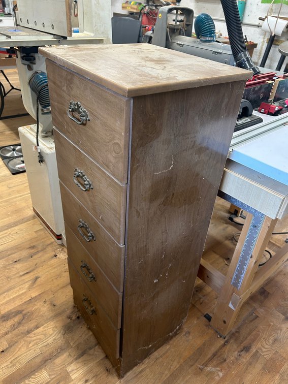 Wooden chest of drawers with contents