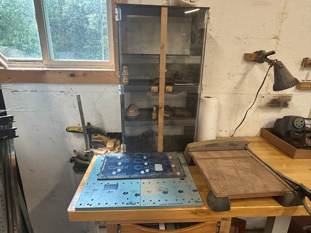 Paper cutter, small plastic display case, wooden clamps