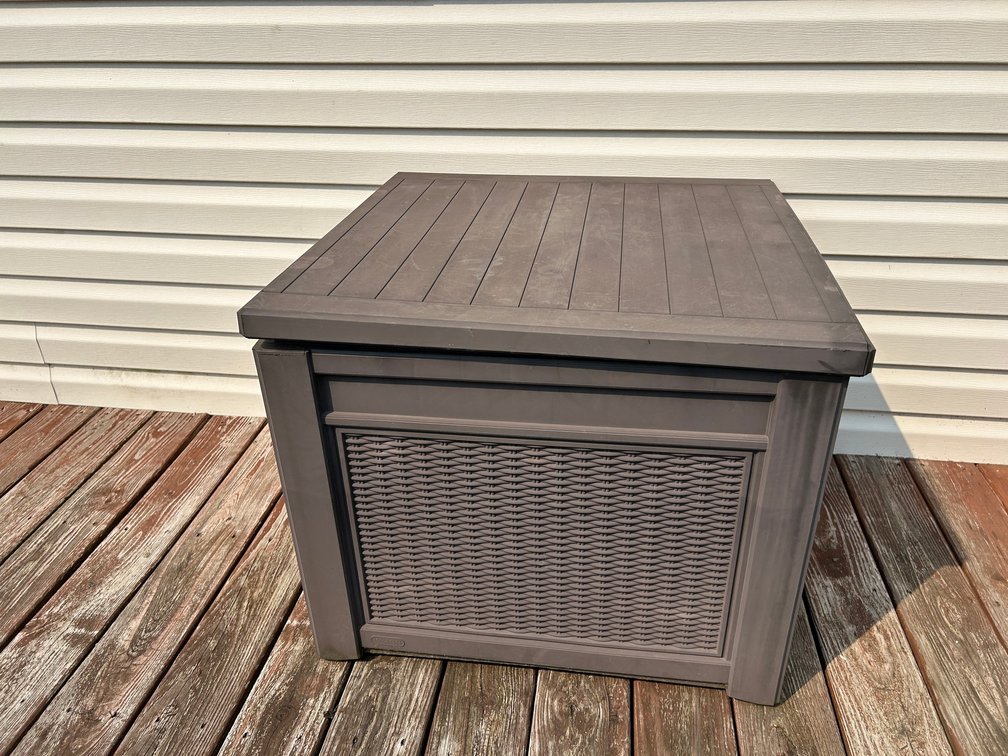 Outdoor plastic storage container with patio cushions