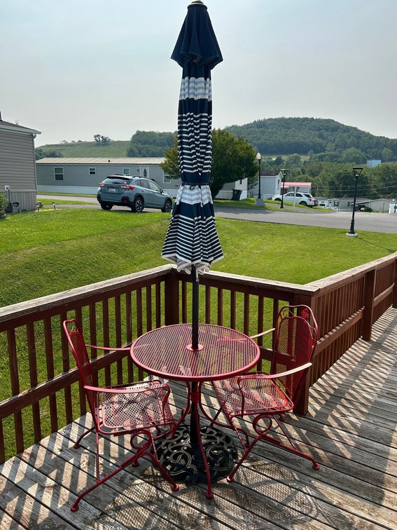 Outdoor patio wire mesh table with chairs and umbrella