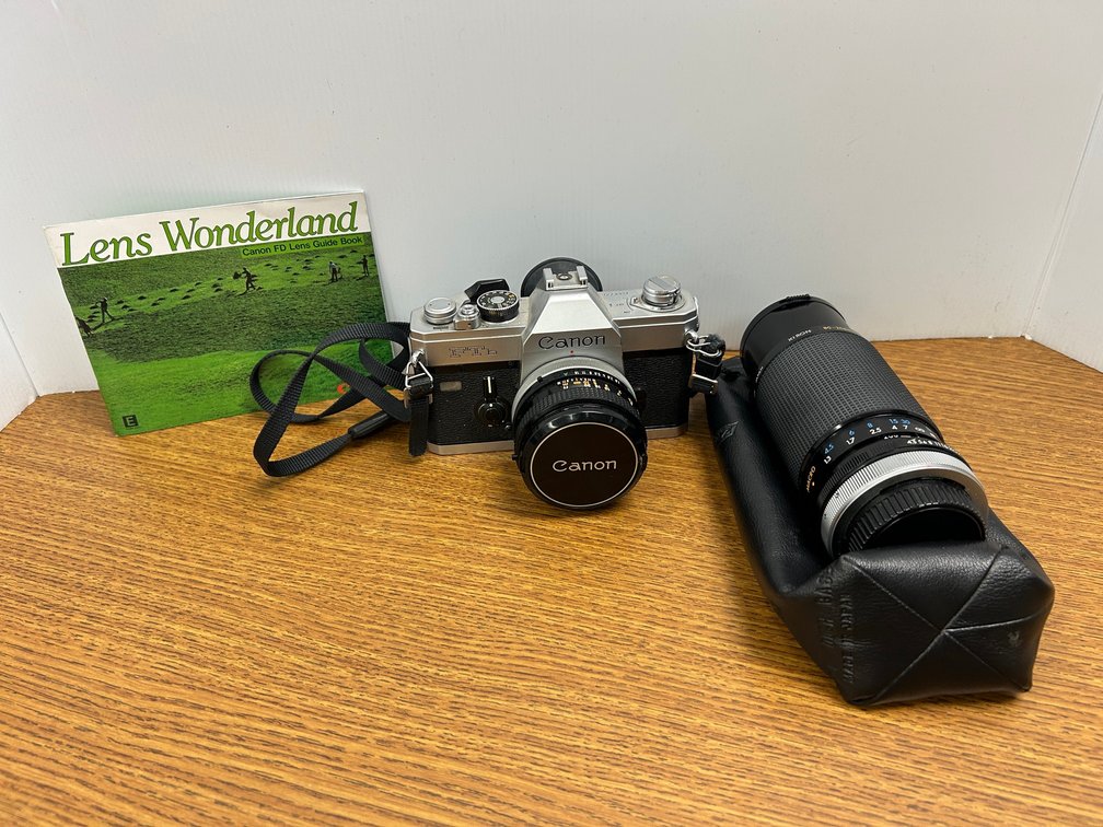 Canon camera, lens, booklet