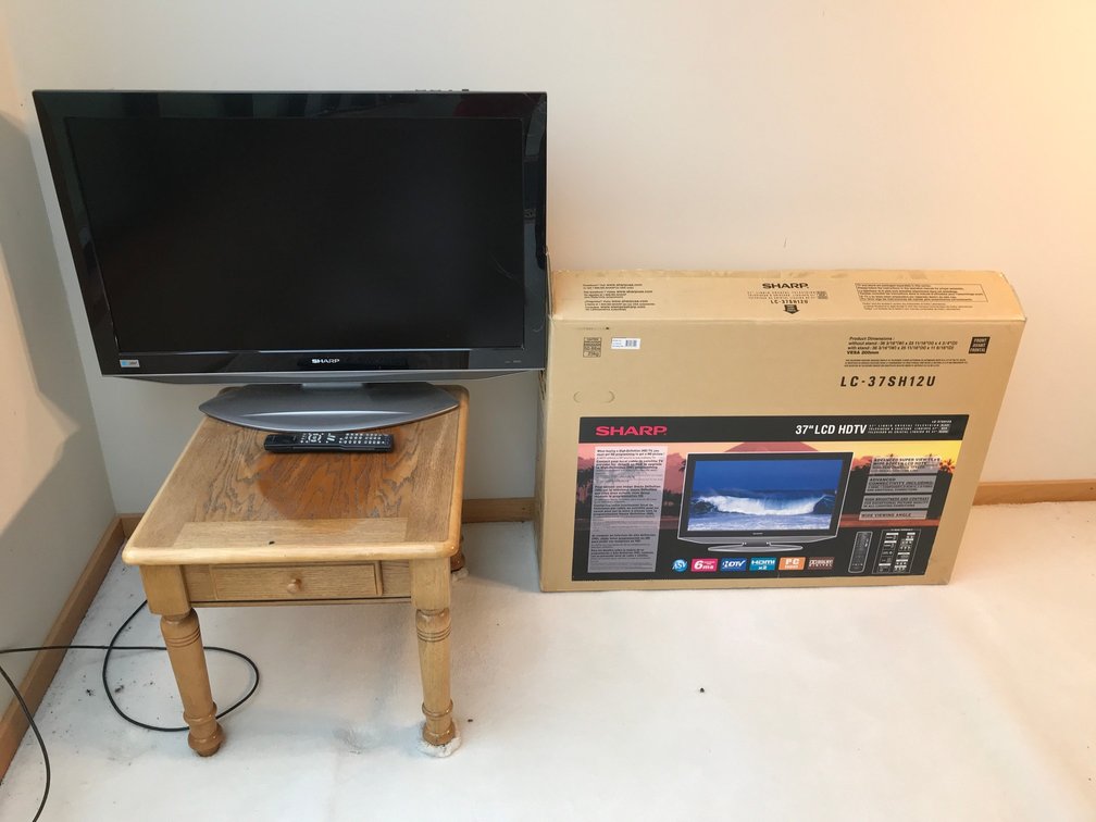 Sharp television with remote and table