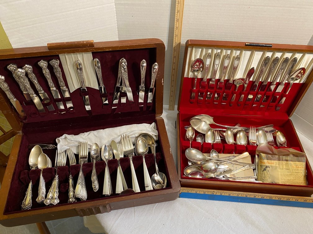 Assorted flatware sets in 2 storage containers